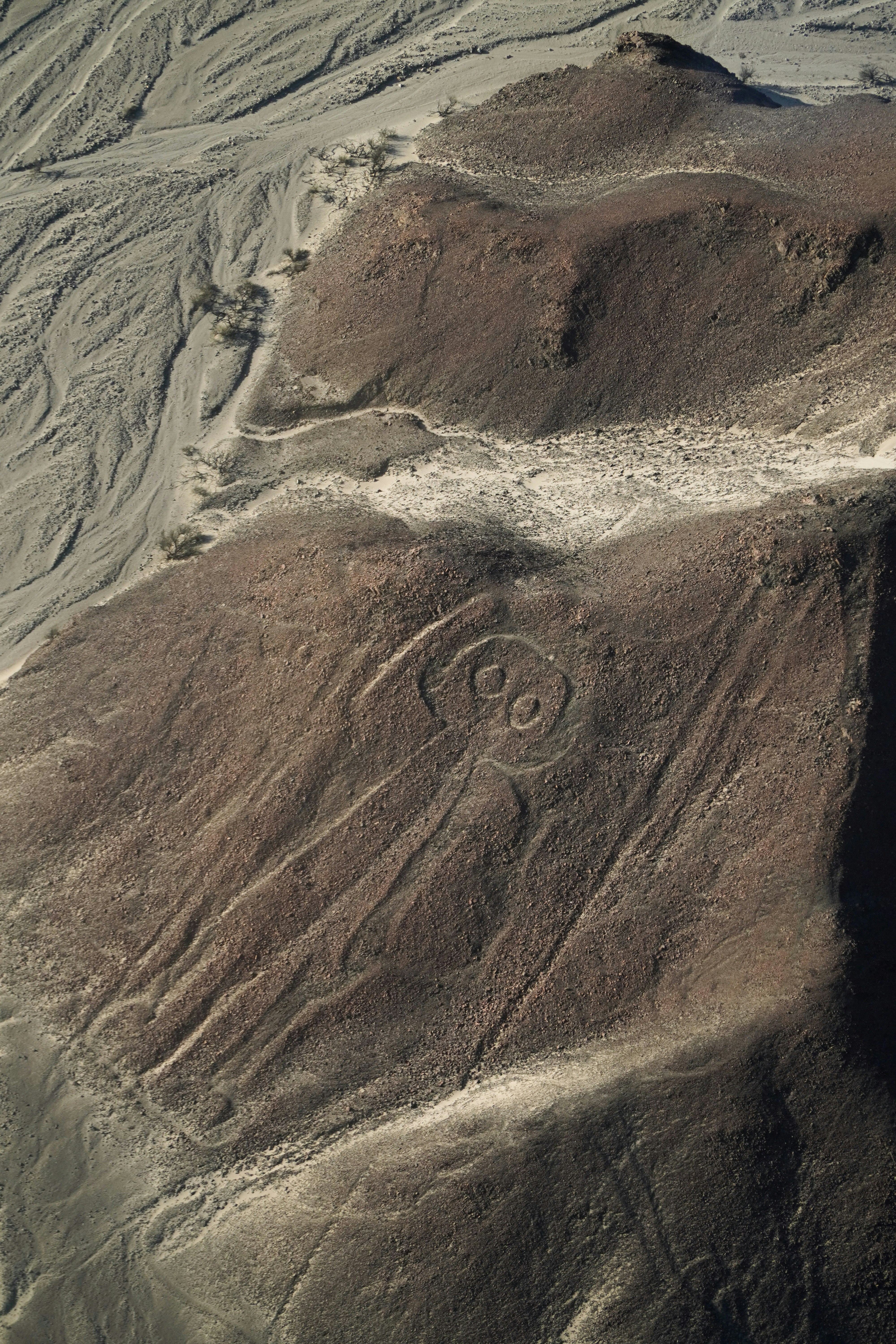 Aerial view of the Astronaut geoglyph carved into the Nazca desert, Peru