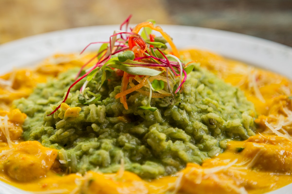 Arequipa-style dish with ají sauce and green rice at a Peruvian restaurant