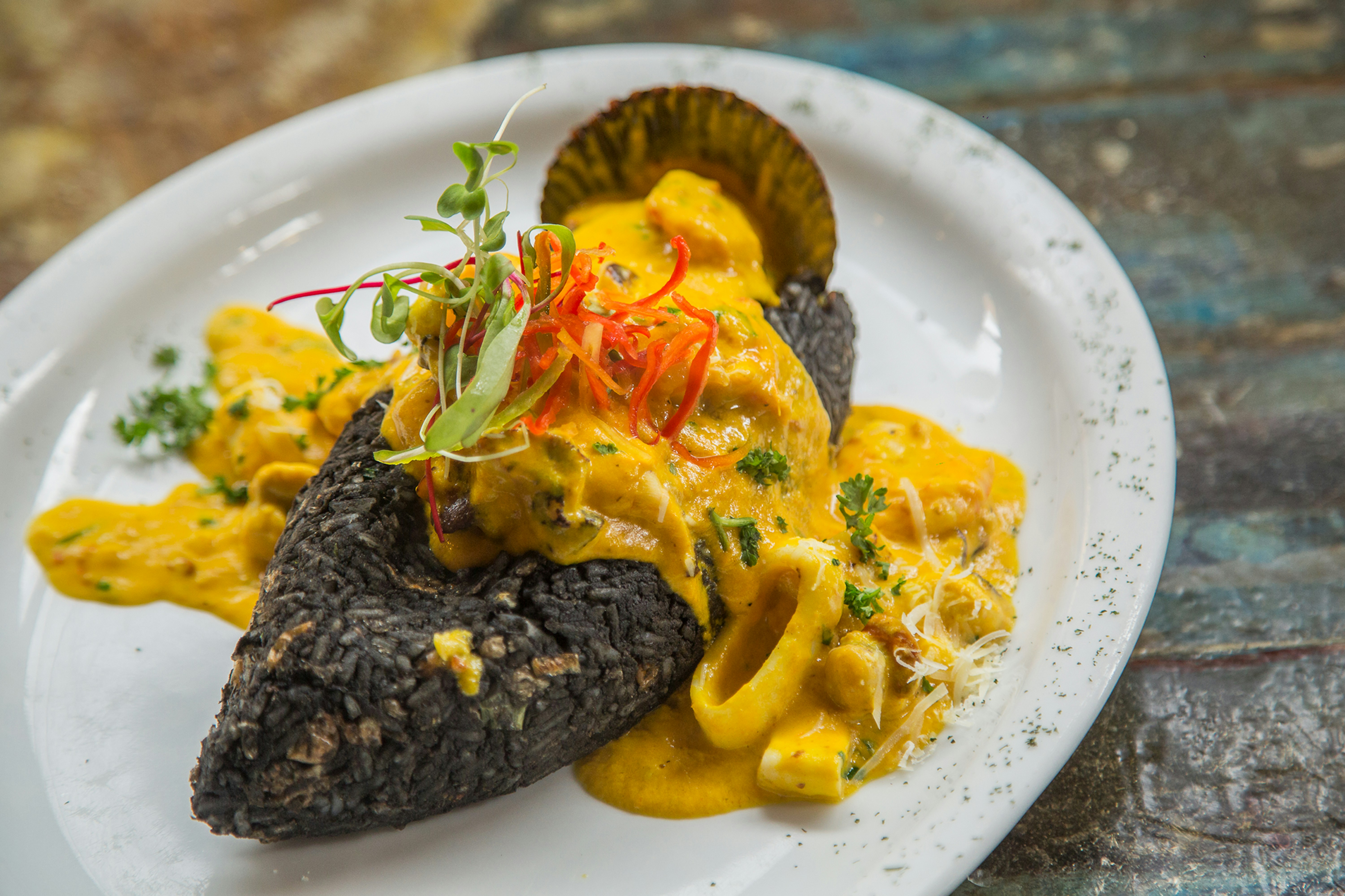 Traditional Peruvian restaurant dish with yellow aji amarillo sauce, Peru