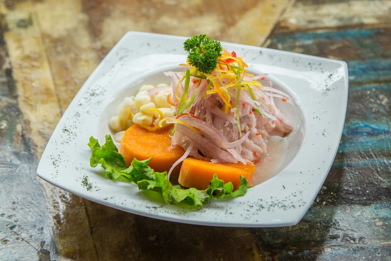 Ceviche clasico limeno con pescado blanco, cebolla morada, aji amarillo y maiz choclo, Lima Peru