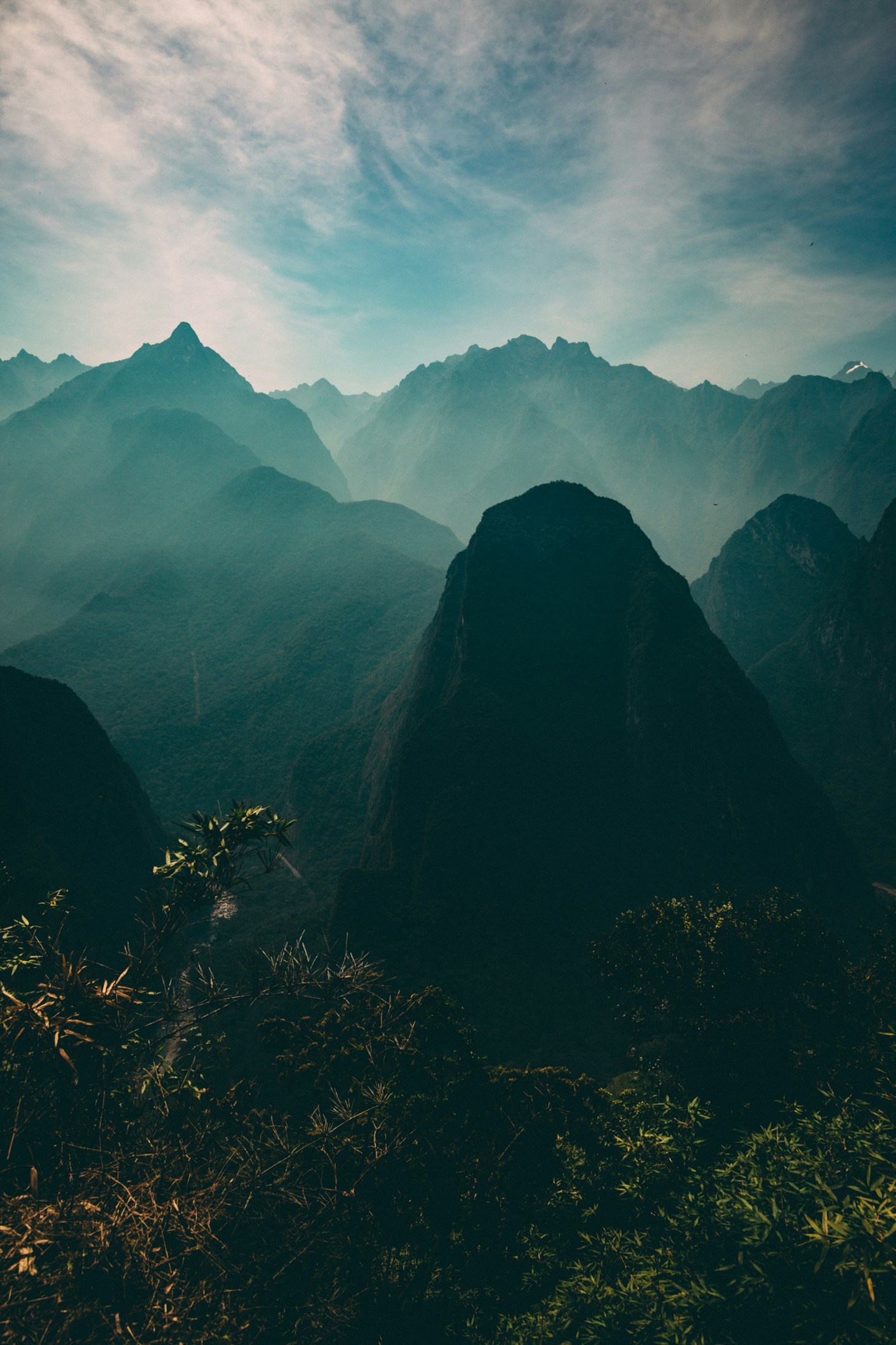 Misty Andean mountain peaks layered in green mist, highlands near Cajamarca Peru