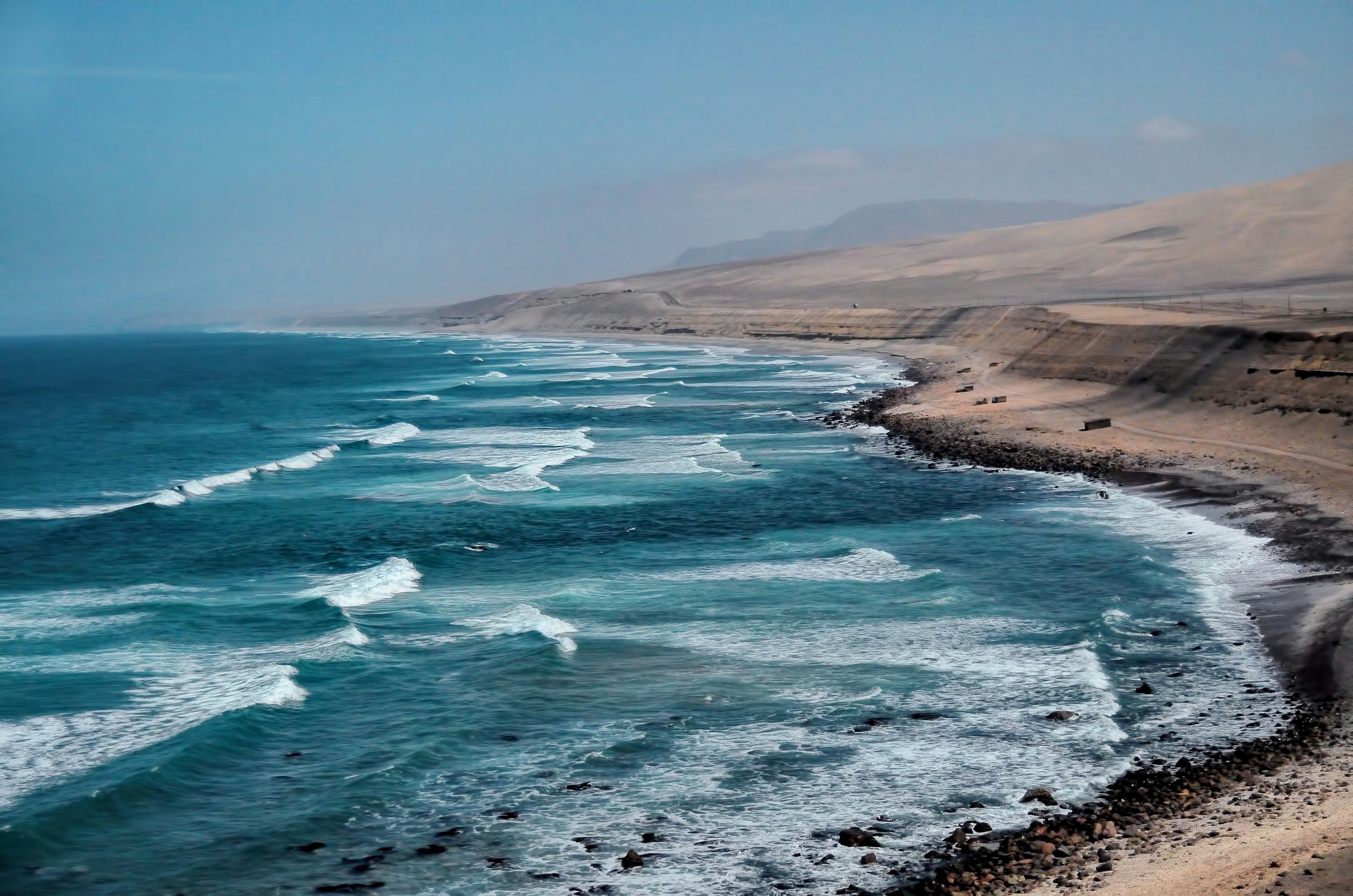 Turquoise Pacific waves breaking along the arid north Peru coastline near Chiclayo