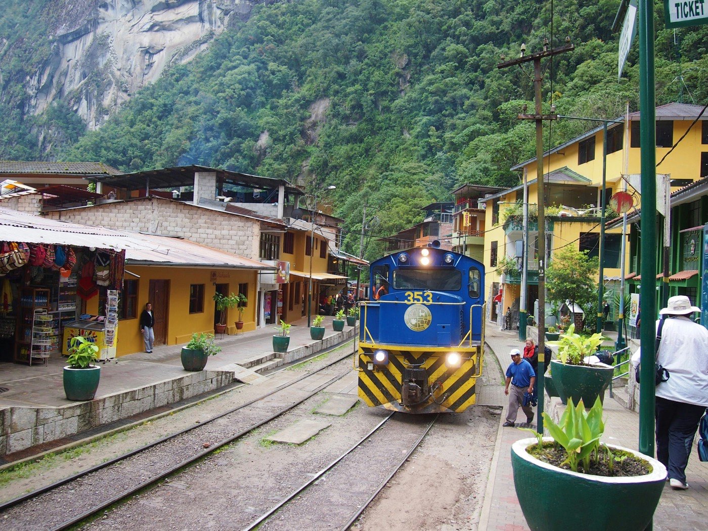 PeruRail train arriving through the main street of Aguas Calientes, Peru