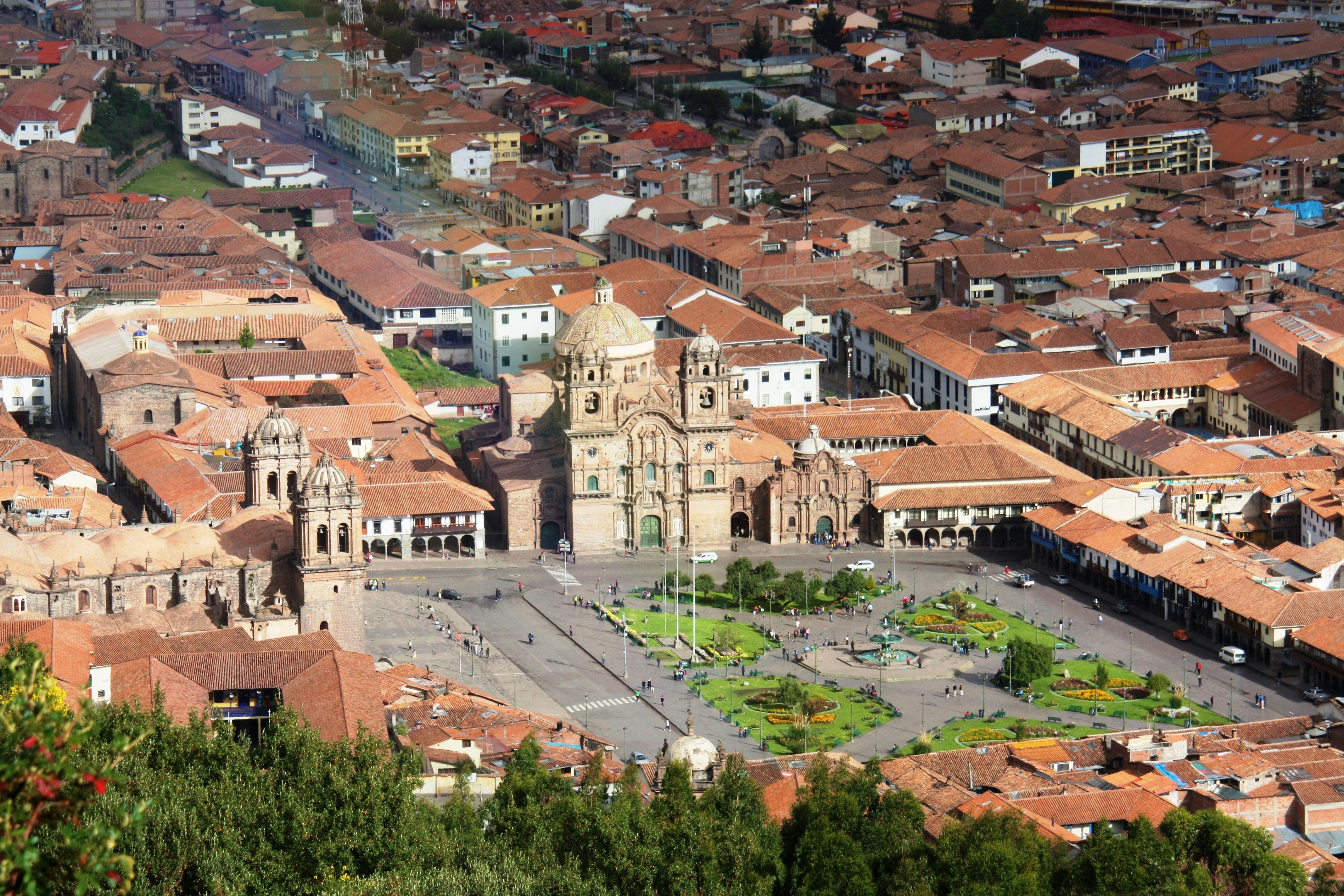 Plaza de Armas in Cusco with the Cathedral and fountain at dusk