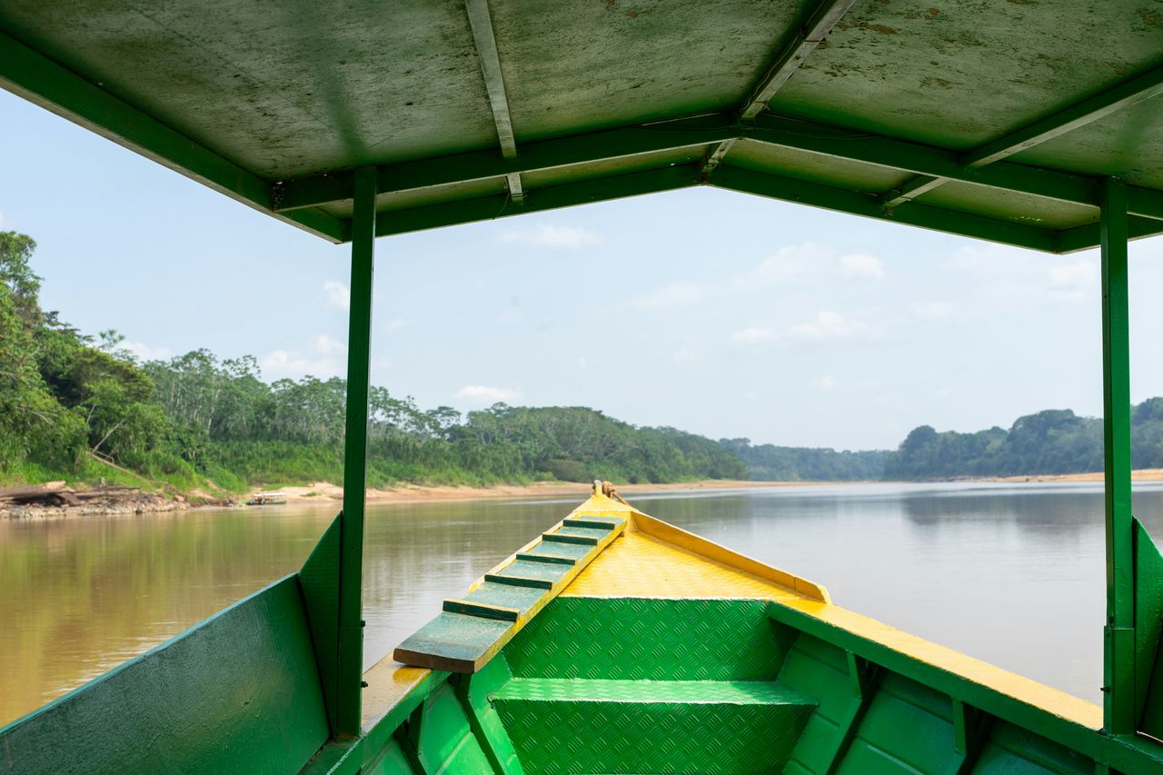 View from inside a green and yellow river boat on the Amazon in Peru