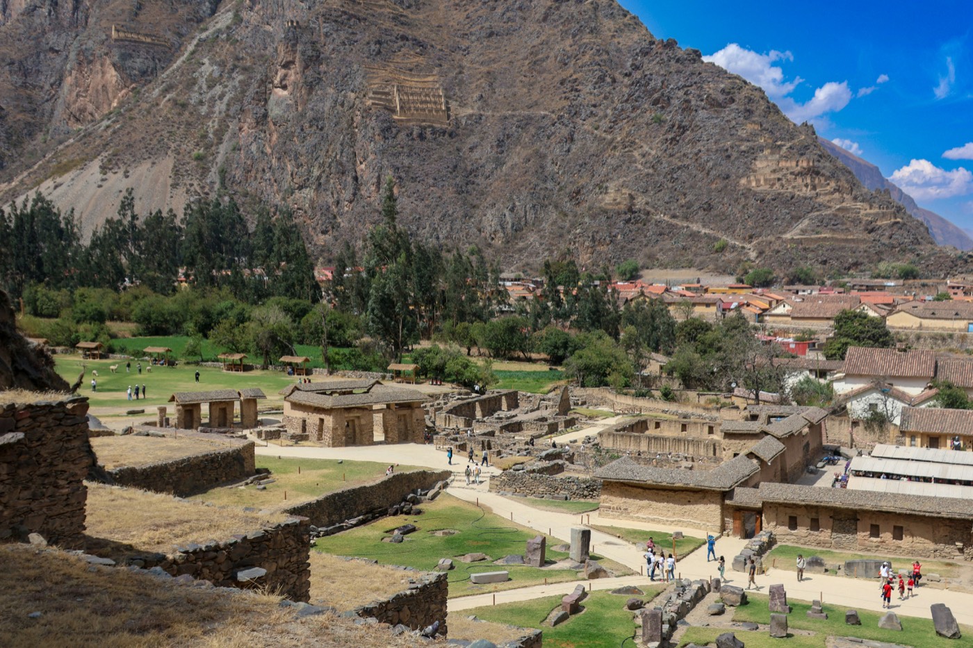 Ollantaytambo ruins and village beneath mountainside Inca granaries, Peru