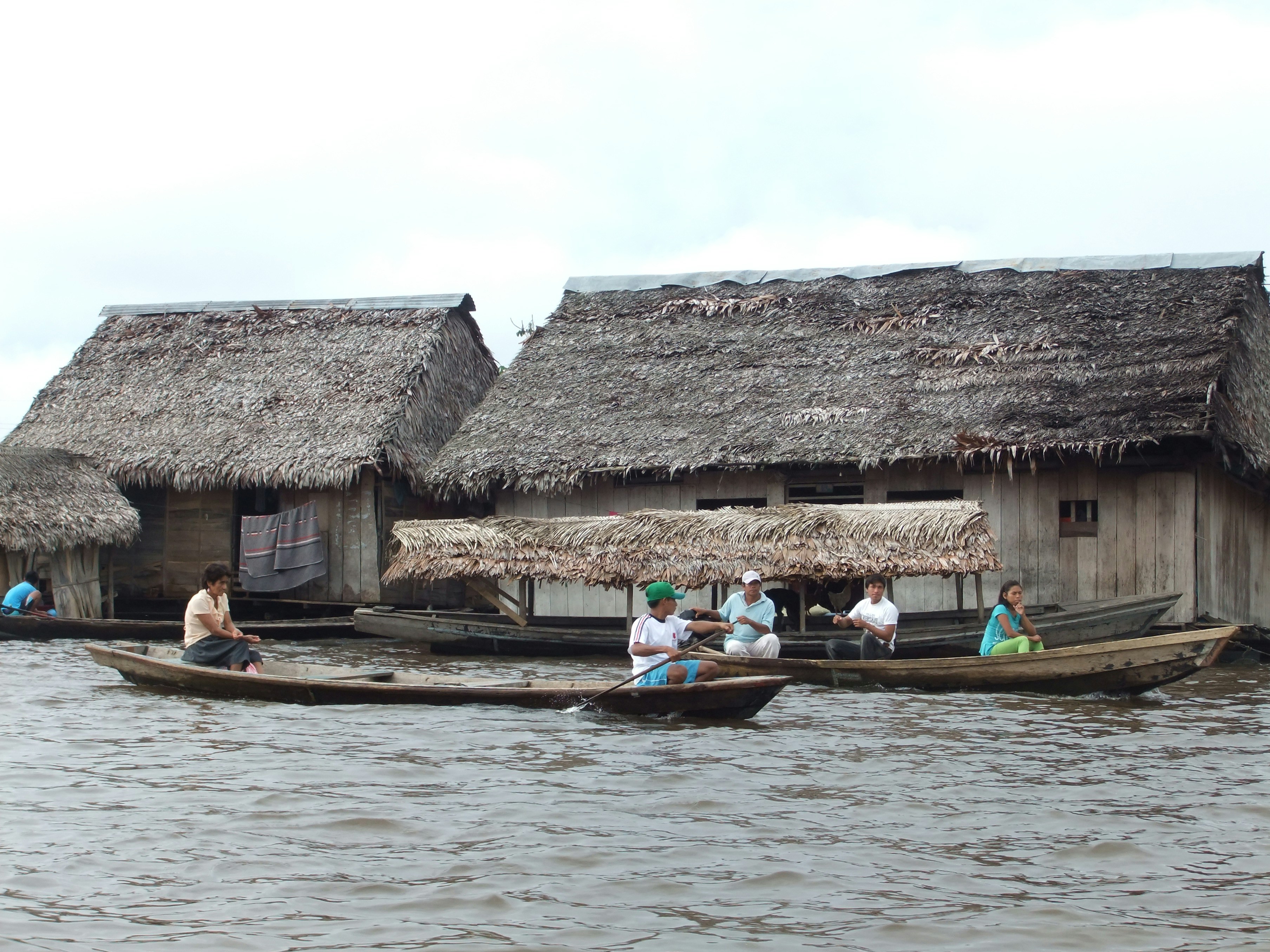 Wooden boats and thatched stilt houses on the water at Belén, Iquitos, Peru