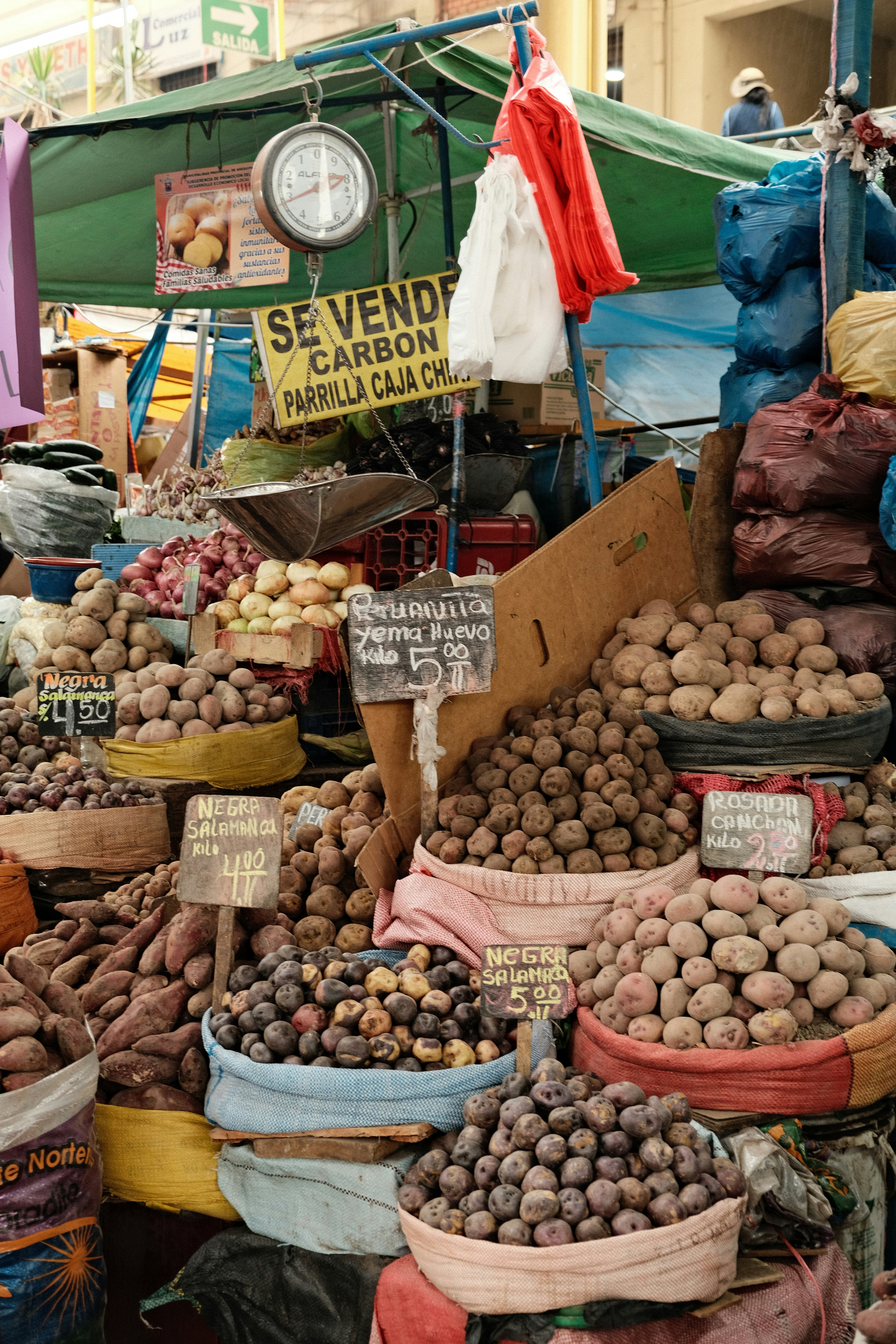 Baskets of fresh potatoes and produce at a Peruvian market stall