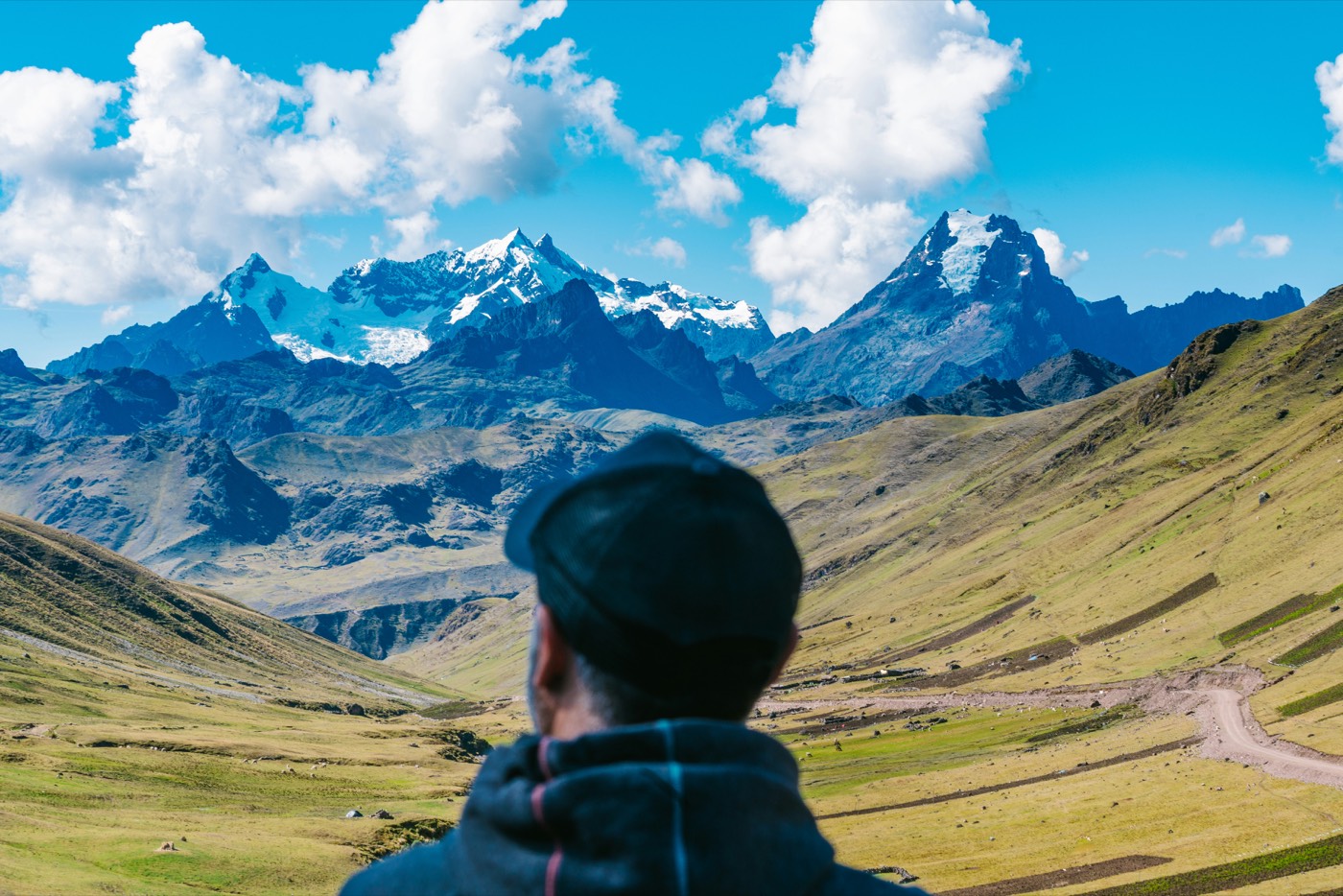 Hiker looking at snow-capped Andes peaks above the Sacred Valley, Peru