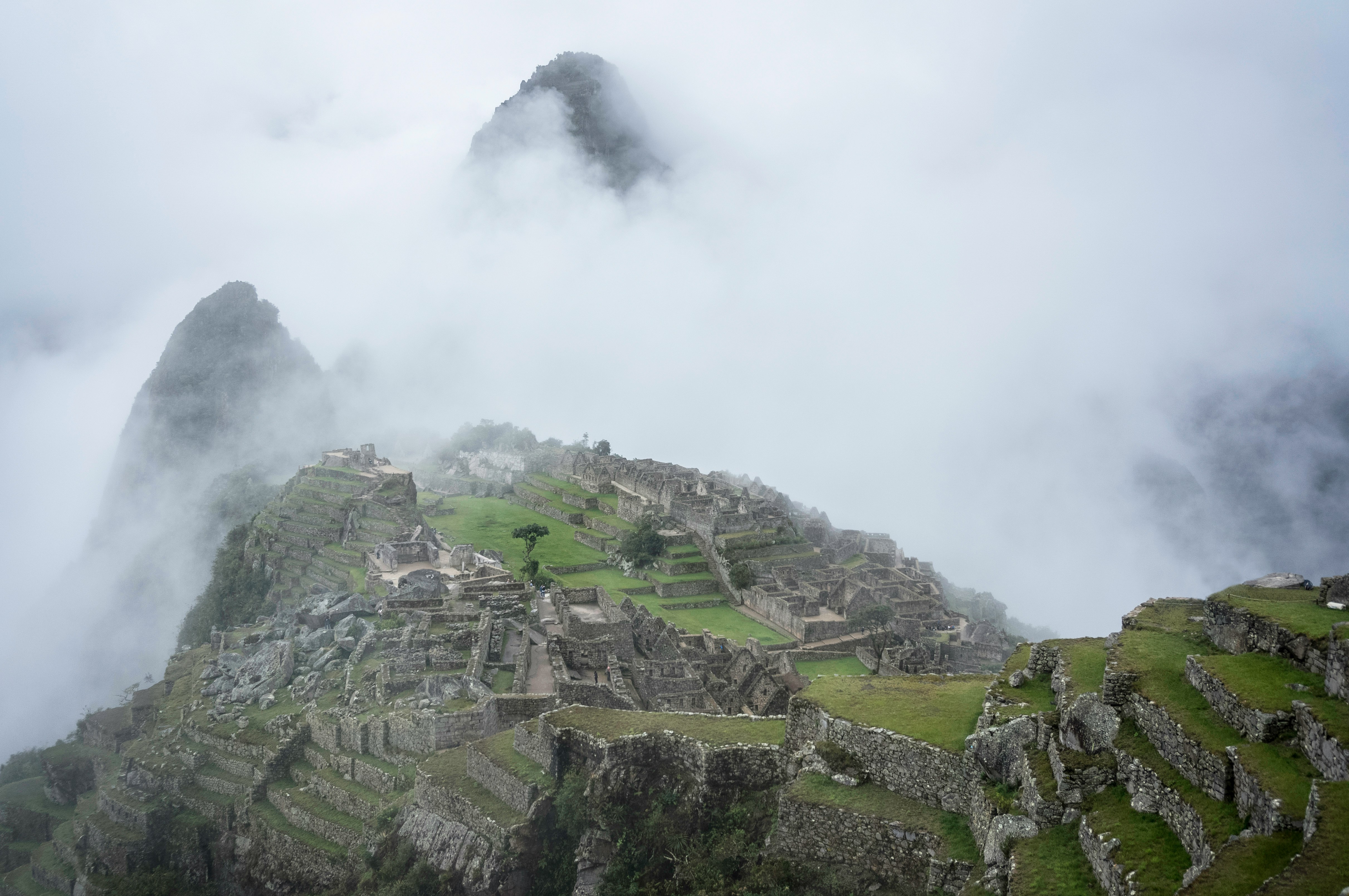 Machu Picchu ruins shrouded in morning cloud and mist, wet season Peru