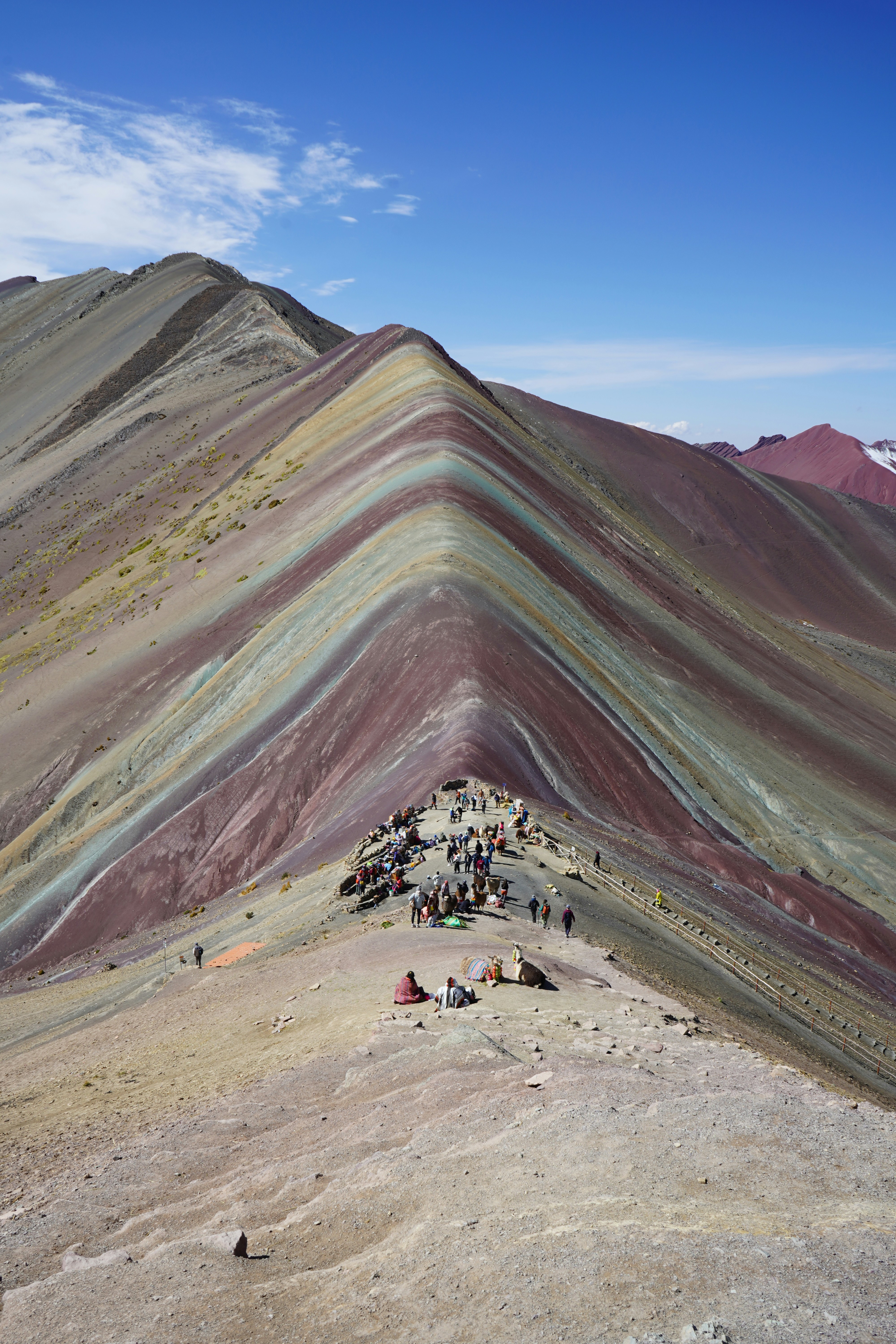 Rainbow Mountain Vinicunca with visitors under clear dry-season sky, Peru