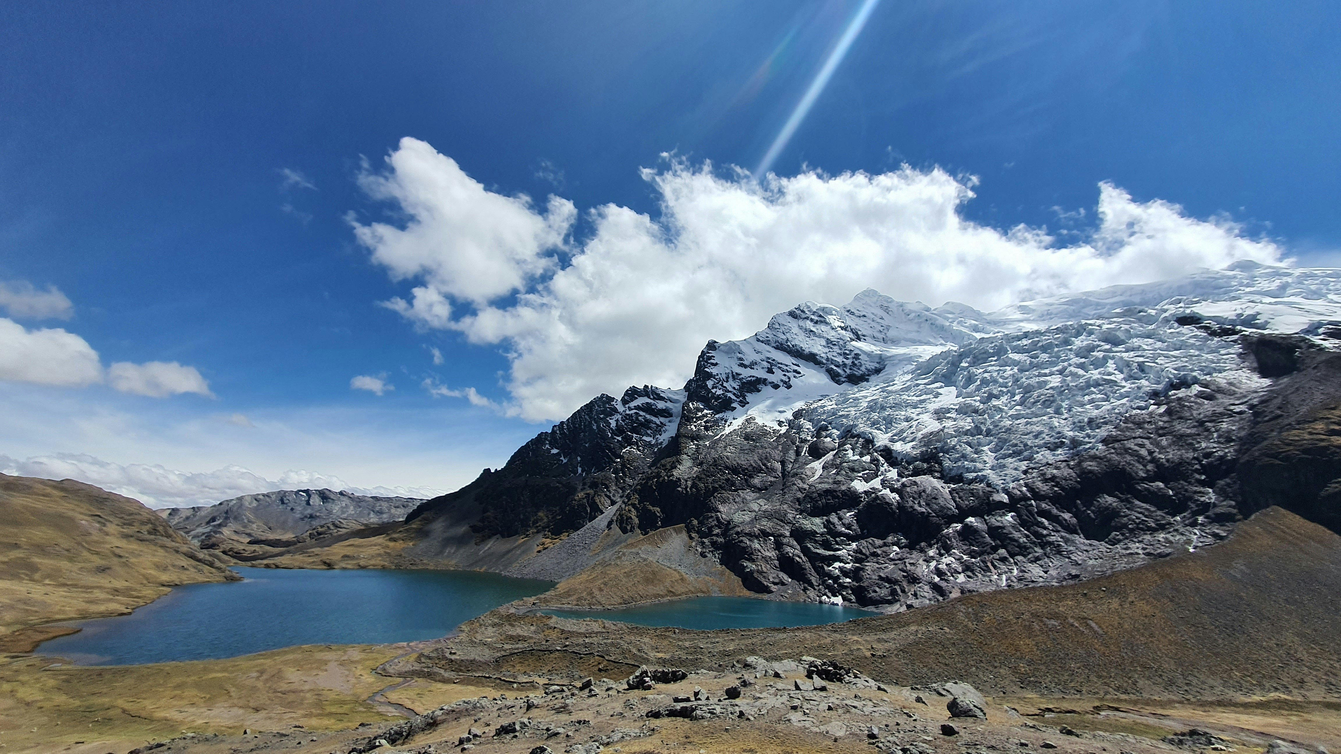 Glacial Andean lake with snow-capped peaks in the Cusco highlands, Peru