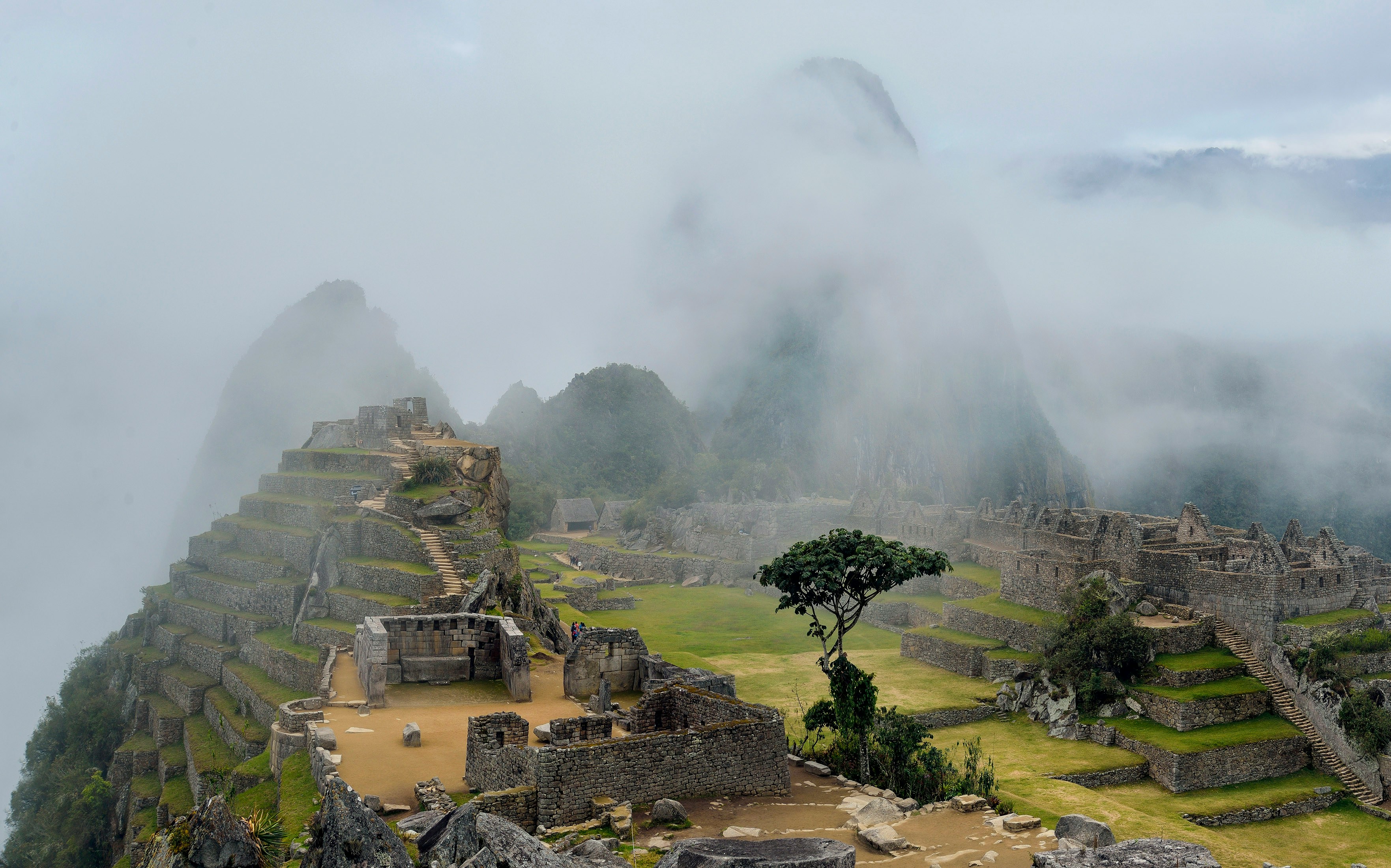 Machu Picchu ruins wrapped in morning cloud and Andean fog