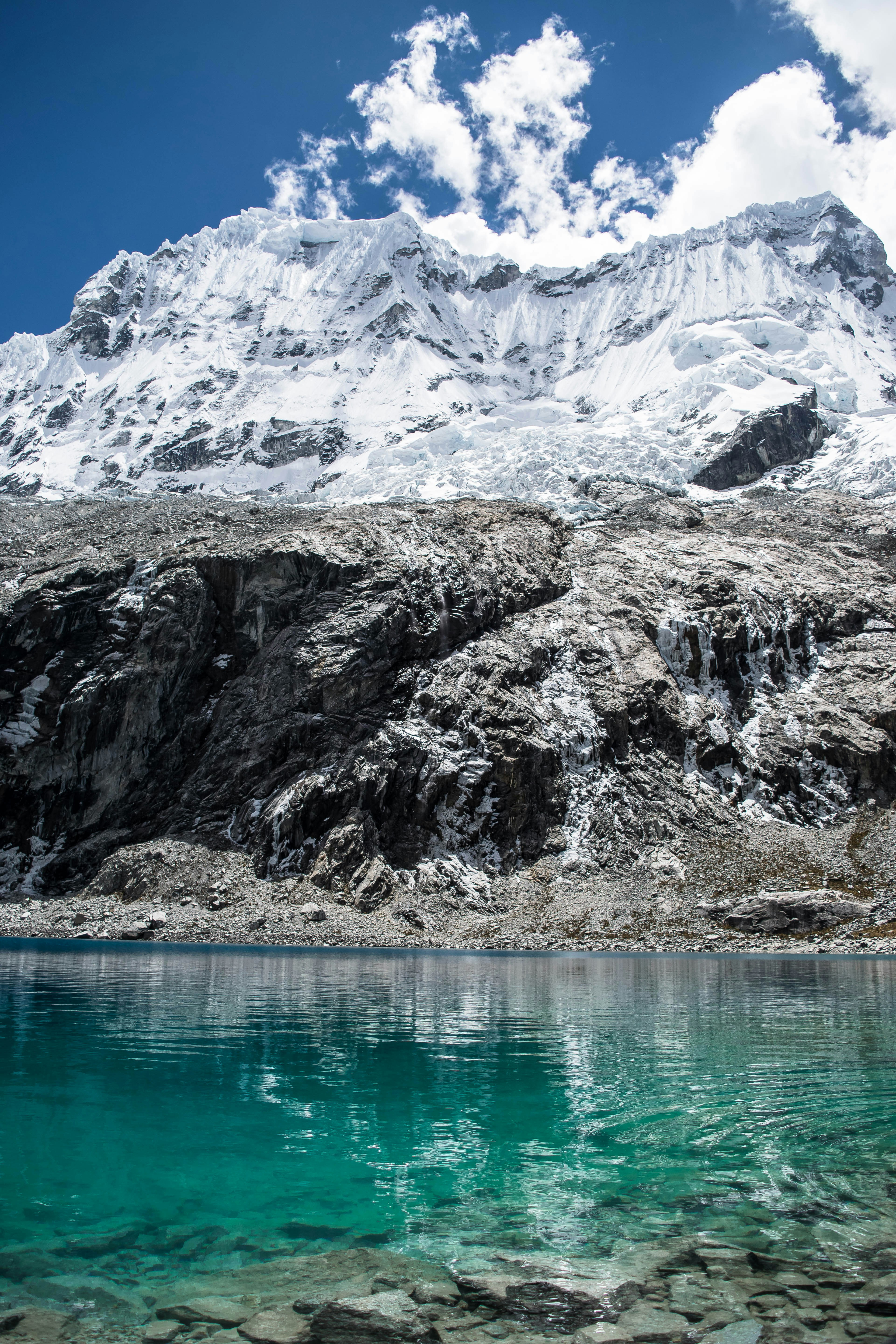 Laguna 69 turquoise glacial lake beneath snow-capped Cordillera Blanca peaks, Huaraz