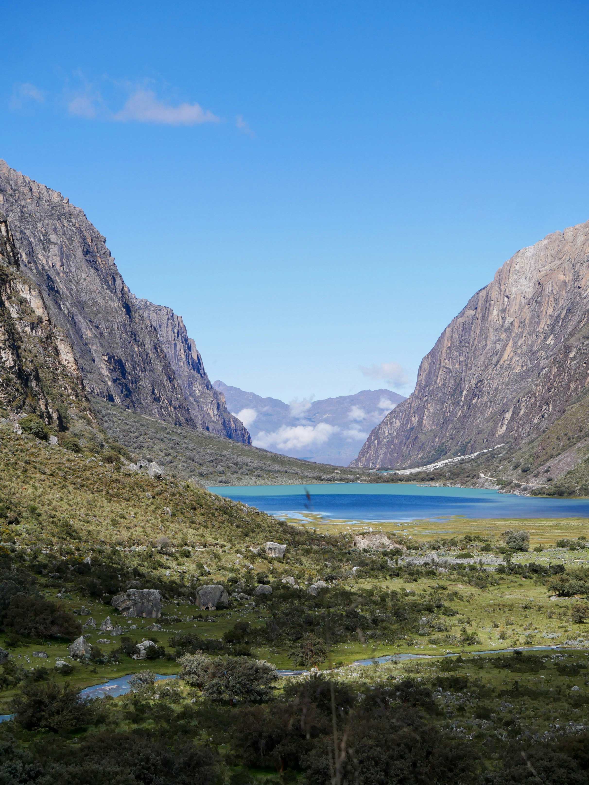 Turquoise glacial lake in a steep-walled valley in the Cordillera Huayhuash, Peru