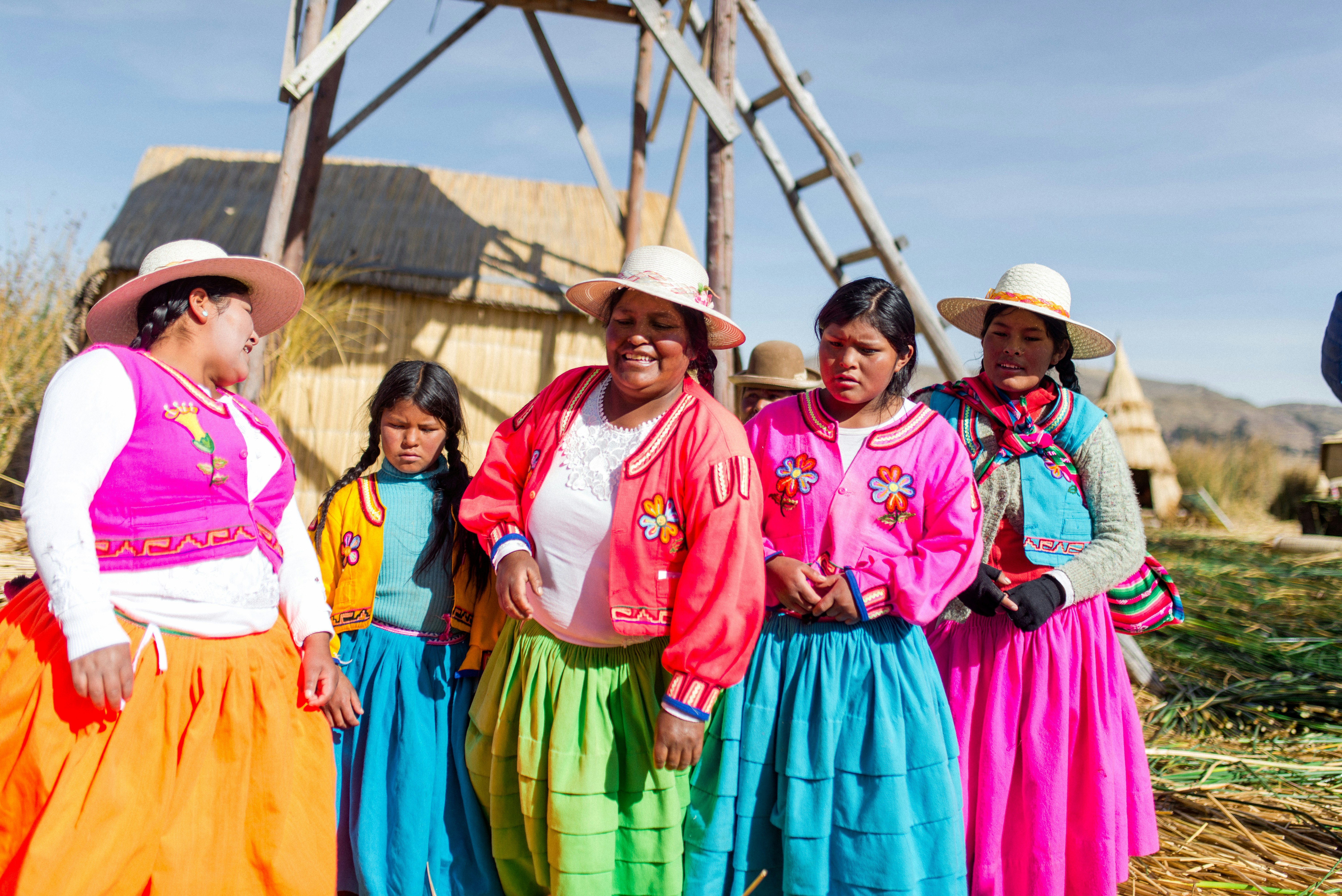 Uros women in traditional dress on Lake Titicaca, Peru
