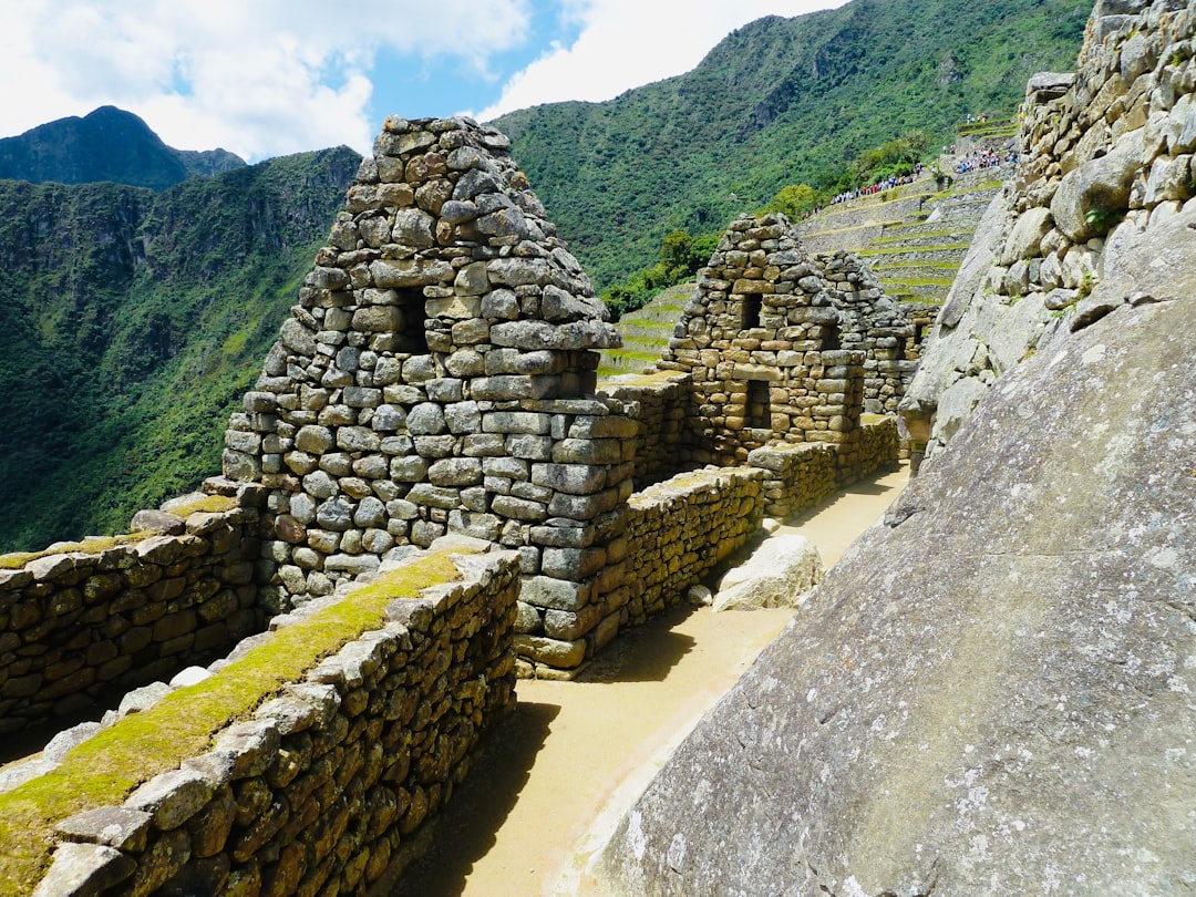 Inca stone ruins at Machu Picchu with cloud forest mountains behind, Peru