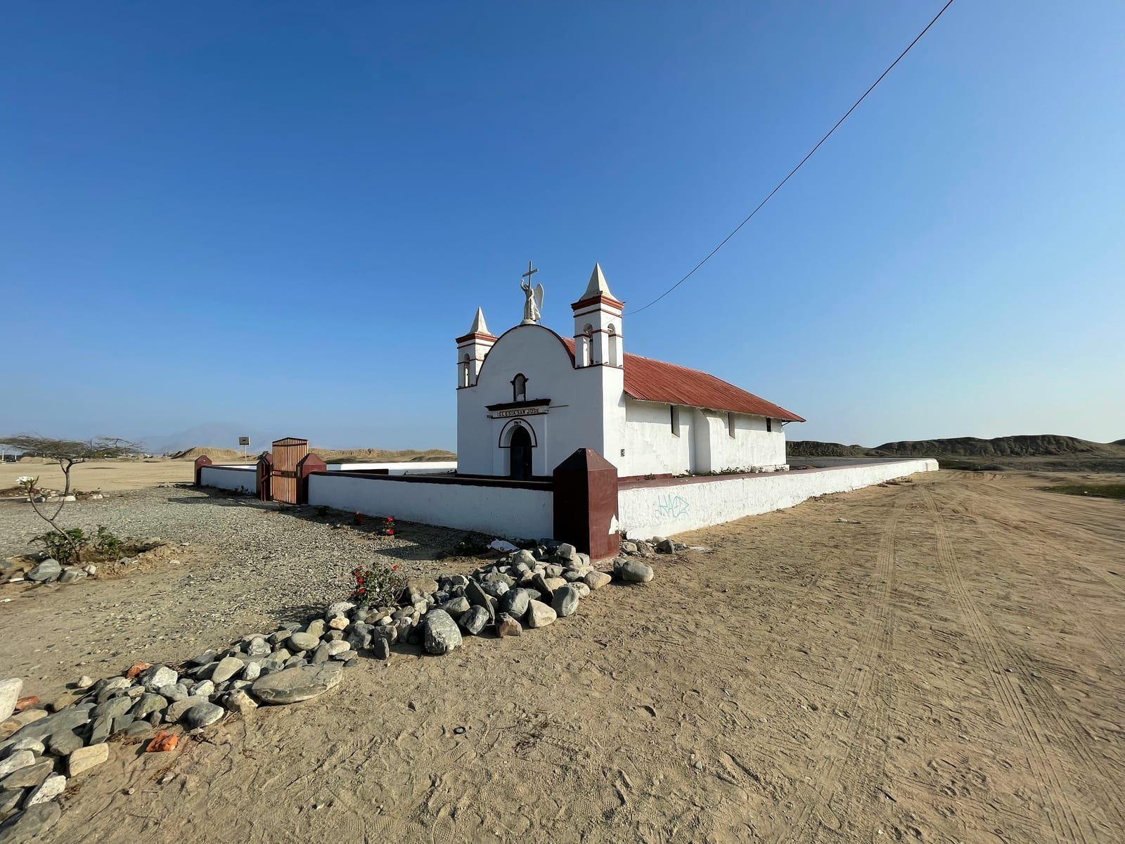 White colonial church in the north coastal desert of Peru near Chiclayo, clear blue sky